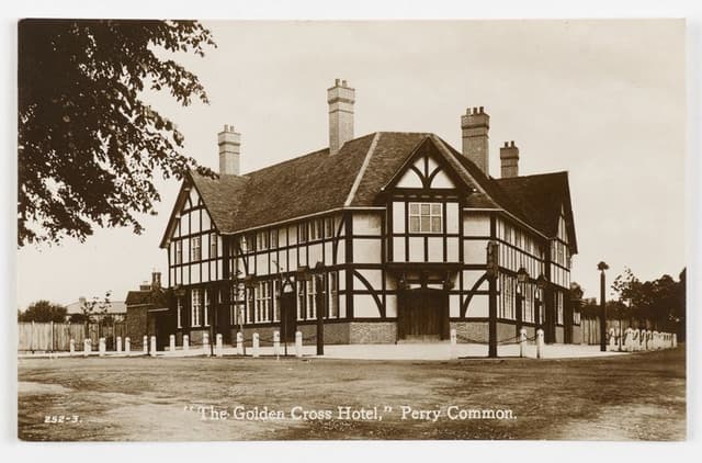 Sepia postcard of the Golden Cross Hotel, Perry Common, a large new mock-Tudor pub with tall chimneys