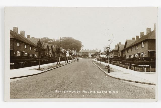 Sepia postcard of the newly built Kettlehouse Road, Kingstanding: matching council houses, saplings and lamp posts along a broad road