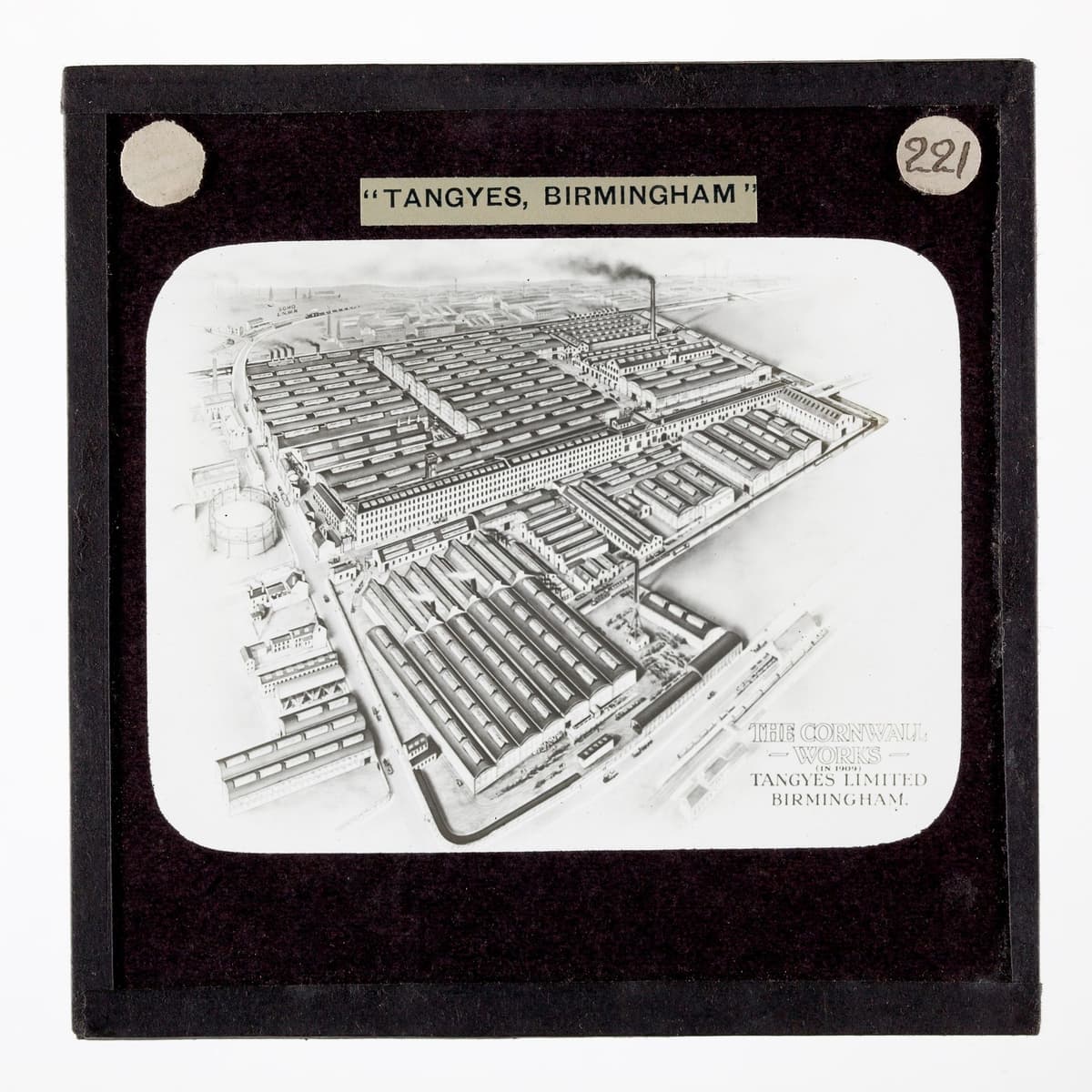 Bird’s-eye illustration of a large factory with many sheds and chimneys beside a canal and railway.
