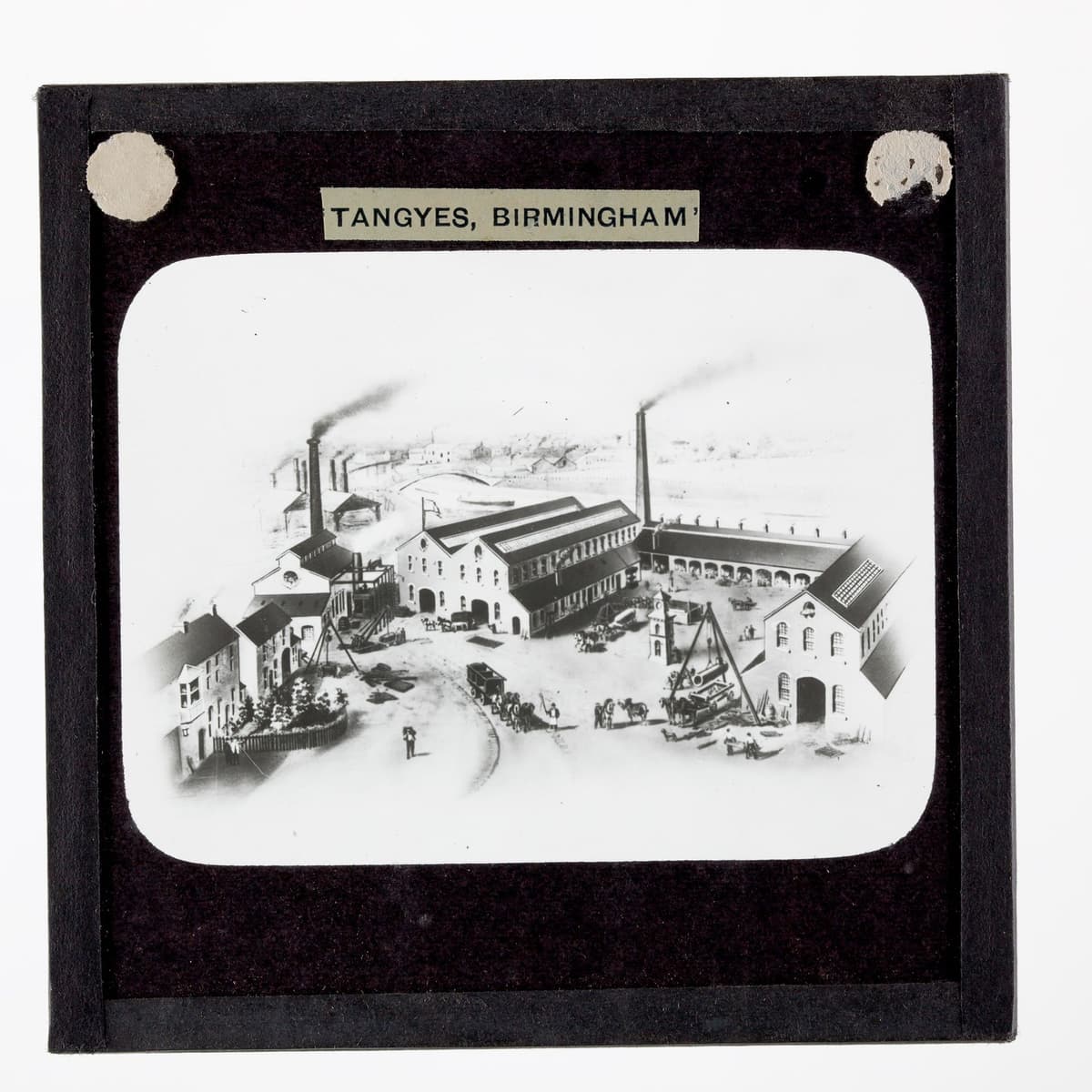 Illustration of the Cornwall Works buildings with chimneys, from a glass lantern slide.
