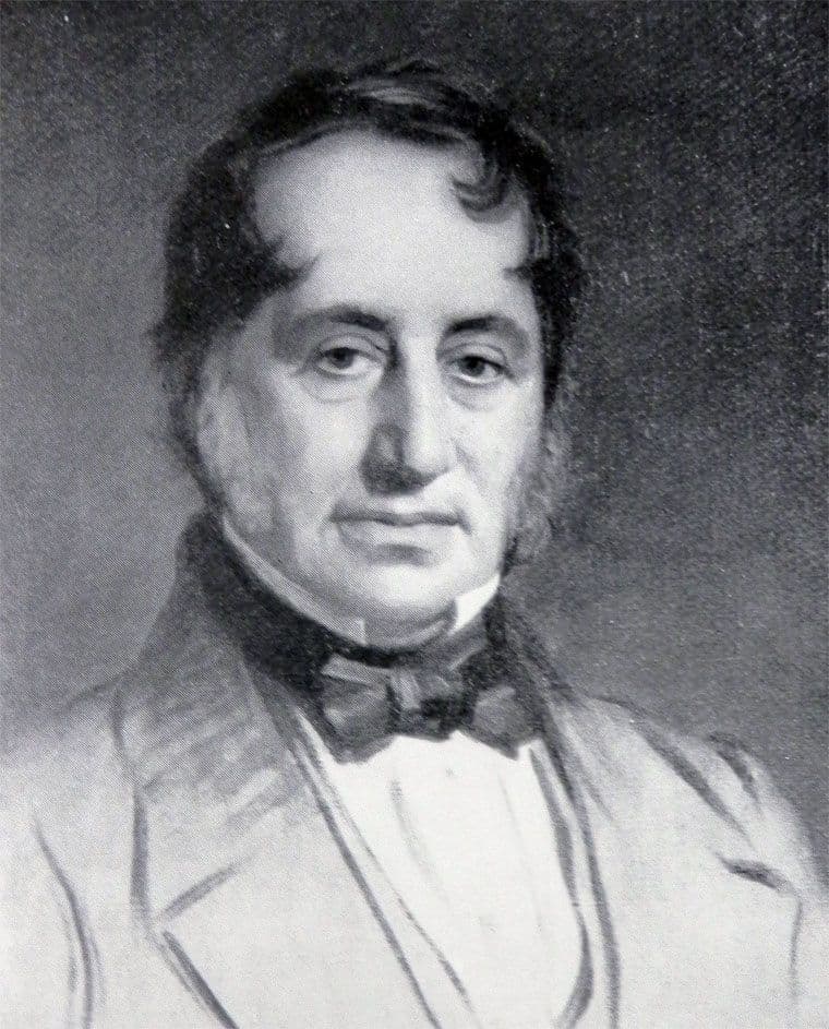 Black-and-white reproduction of a painted portrait of a middle-aged man with dark side-whiskers, a high collar and a dark bow-tied stock.