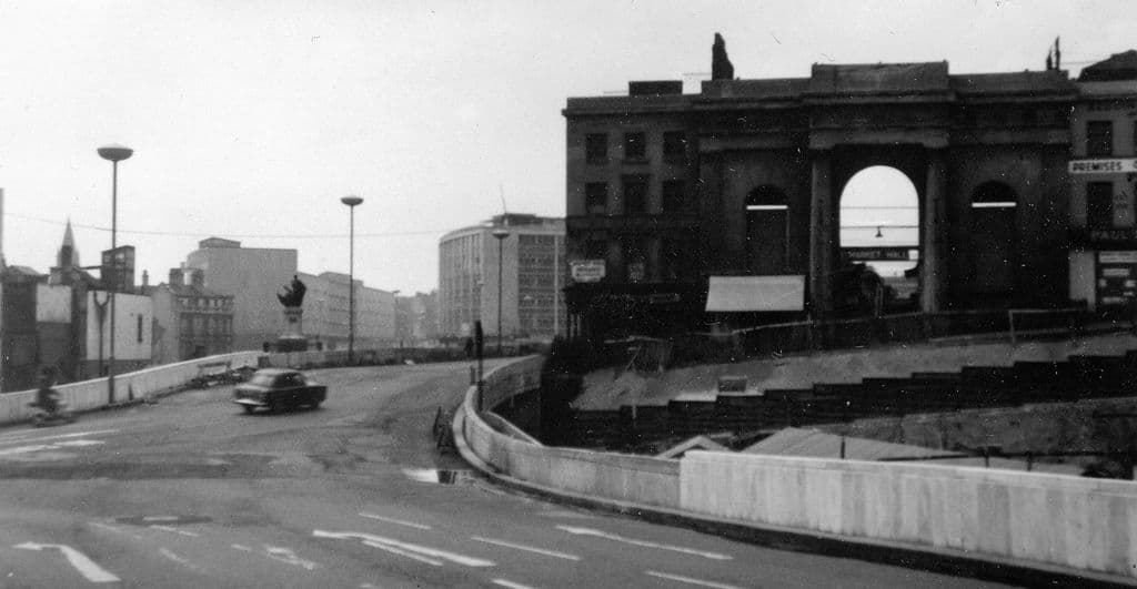 The columned entrance of the old Market Hall, with a new road carriageway to its left.