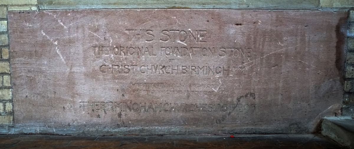 An inscribed foundation stone set inside a church.