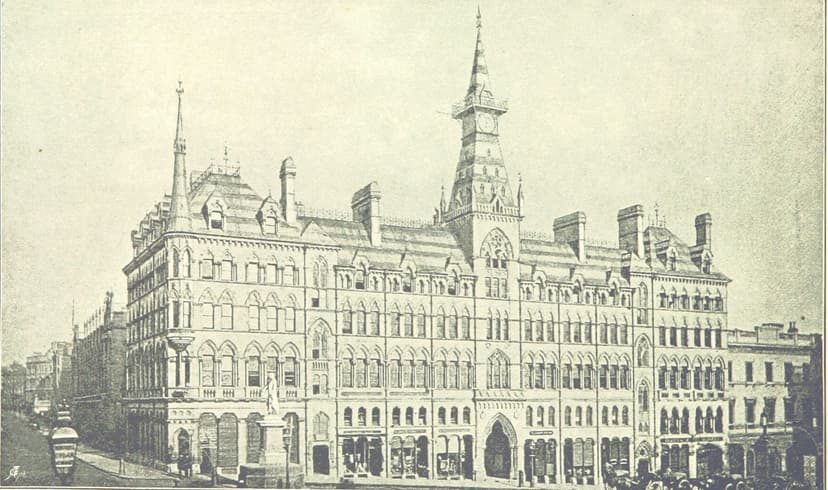 Engraving of a large Gothic stone building on a street corner with a central clock tower and spire, and a statue in front.
