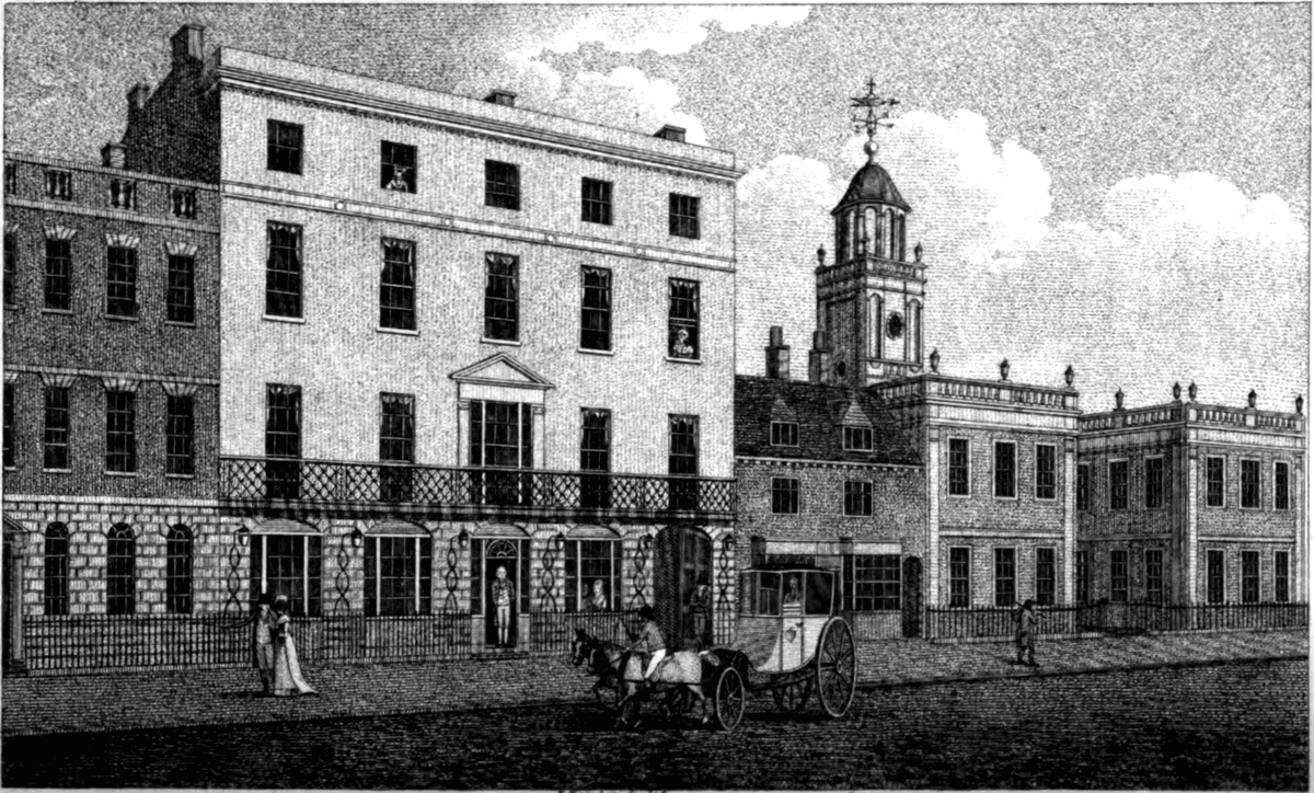 Engraving of a four-storey hotel front with a long iron balcony, beside a school building with a cupola.