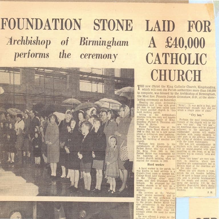 A newspaper cutting headed “Foundation stone laid for a £40,000 Catholic church – Archbishop of Birmingham performs the ceremony”, with a photograph of women and children, many under umbrellas, standing in the rain in front of the steel frame of the new church, beside two columns of text.