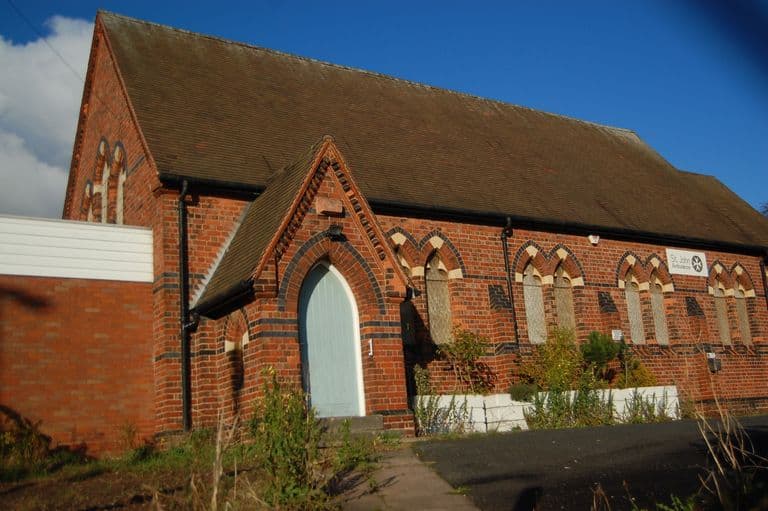 Small Victorian red-brick chapel with a steep tiled roof, gabled porch and pointed windows, shortly before demolition