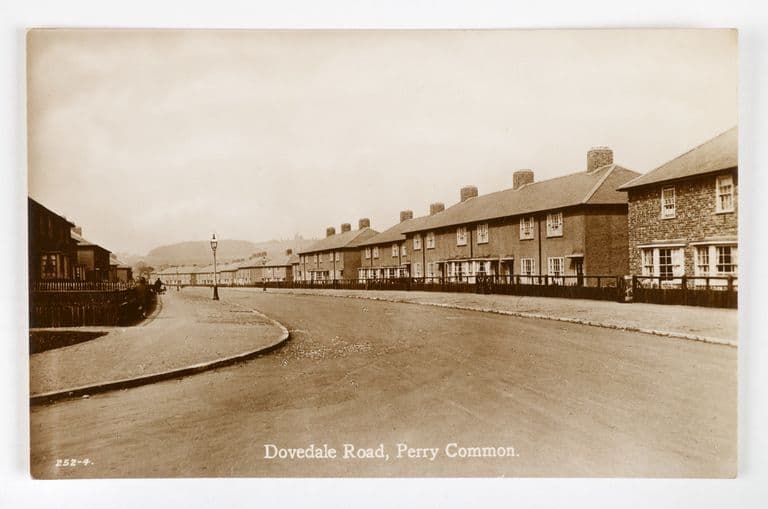 Sepia postcard of Dovedale Road, Perry Common, with long terraces of new council houses curving along the road
