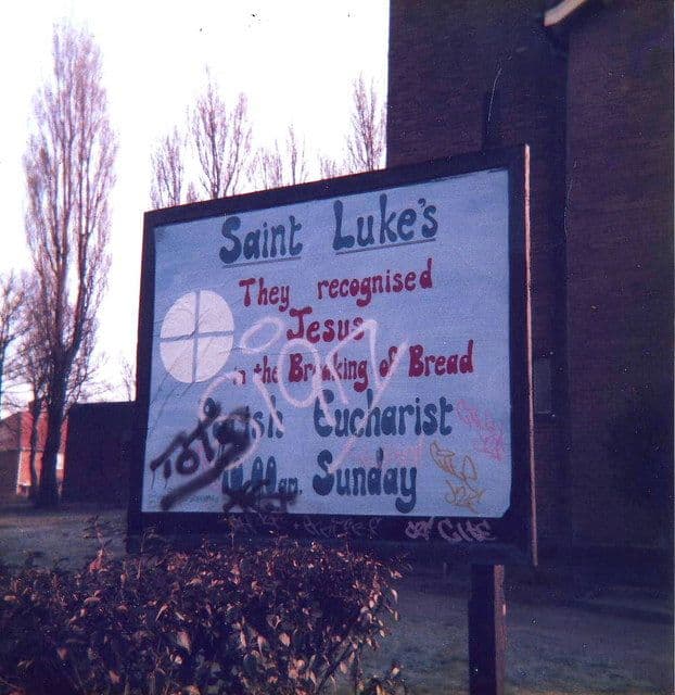 Hand-painted noticeboard outside St Luke’s Church, Kingstanding, in 1987, with graffiti across it