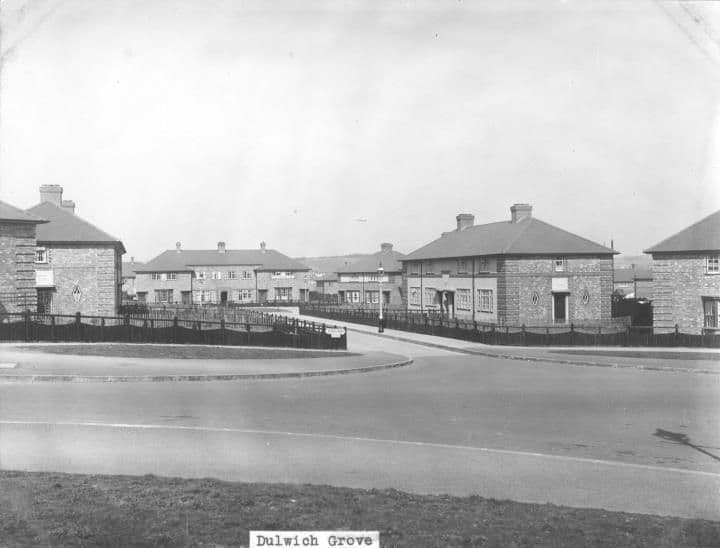 New brick and rendered houses around a wide curved road junction, with fenced front gardens; the print is captioned Dulwich Grove.