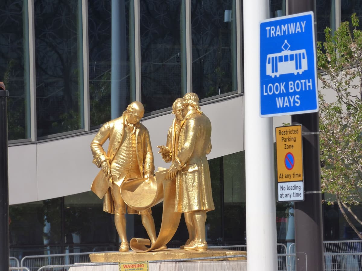 The gilded statue of Boulton, Watt and Murdoch newly reinstalled in Centenary Square.