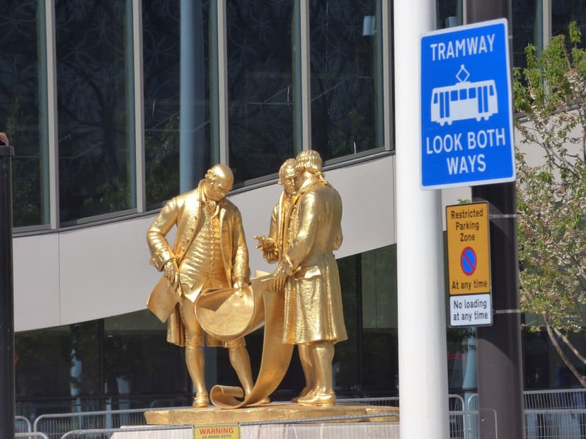 The gilded statue of Boulton, Watt and Murdoch newly reinstalled in Centenary Square.
