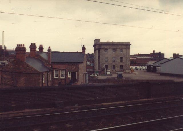 The old Curzon Street building seen from a passing train, surrounded by goods yards.