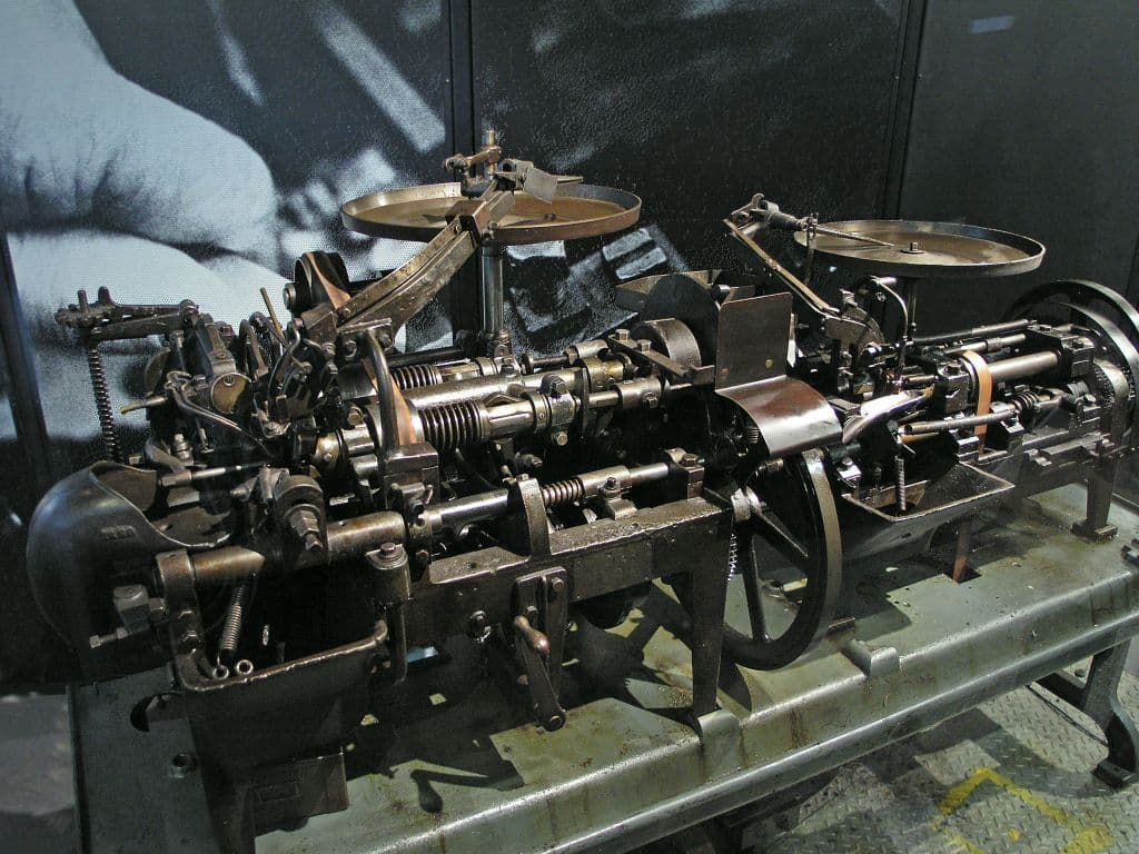 A cast-iron machine for turning and slotting wood screws.