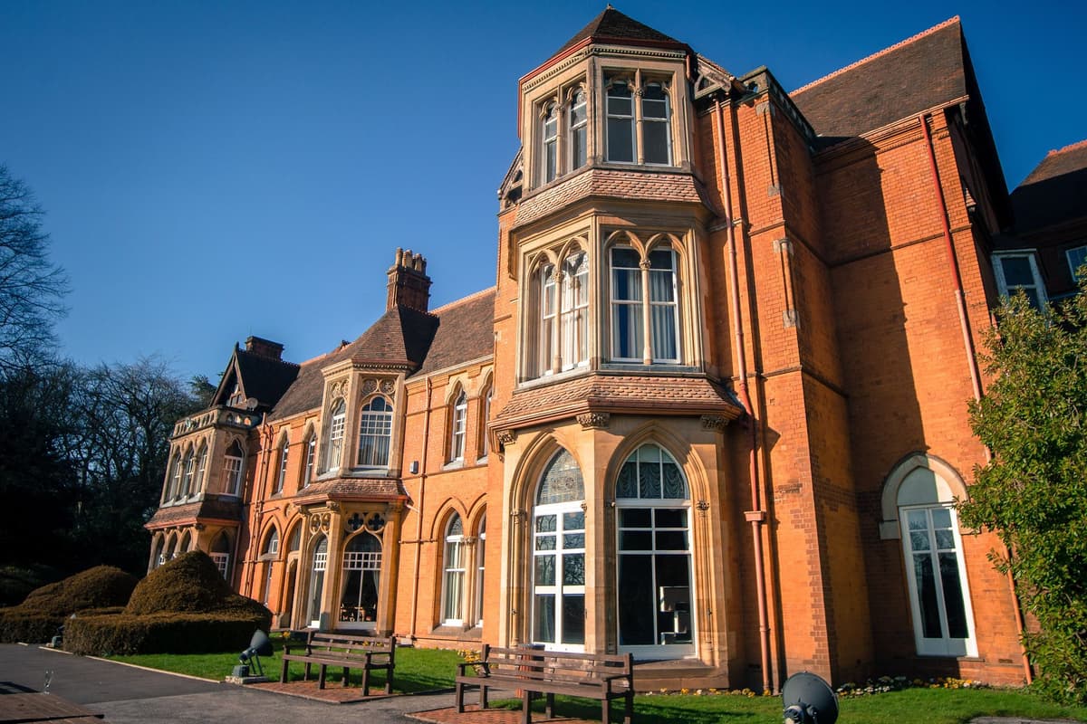Highbury Hall’s red-brick front with carved stone and terracotta details.