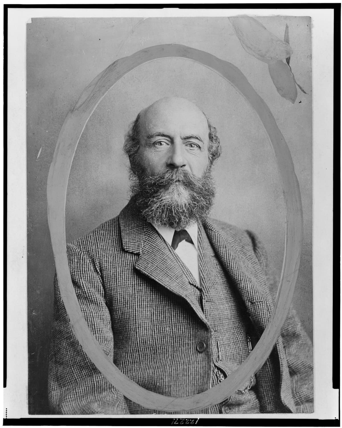 Photograph of a bearded man in a dark suit, facing the camera.