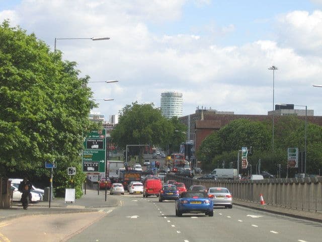 A dual carriageway dipping into an underpass.