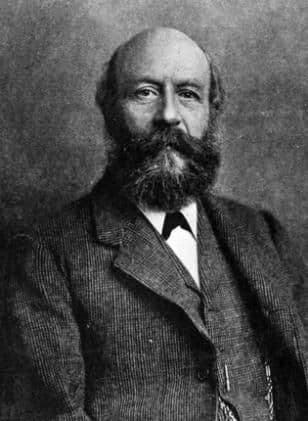 Photograph of a balding man with a full beard, in a jacket, waistcoat and bow tie.