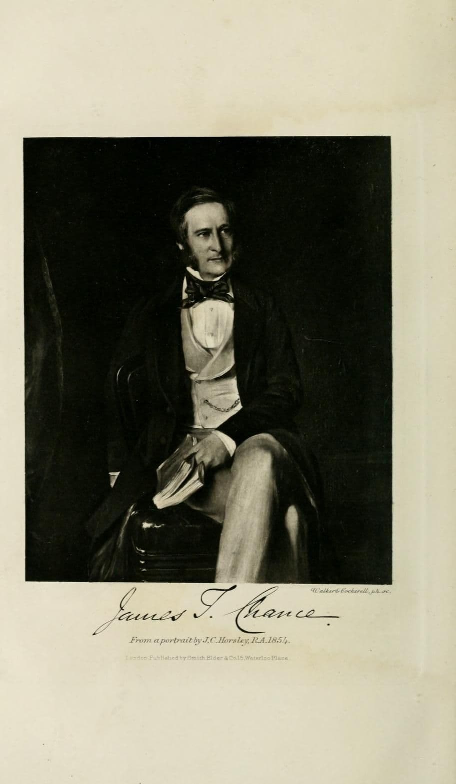 Engraved reproduction of a portrait of a seated man with side-whiskers, bow tie and waistcoat, holding a book, with his signature below.