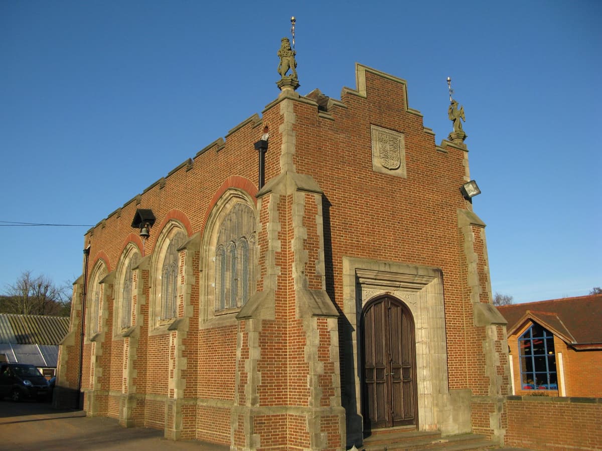 A small battlemented Gothic chapel with buttresses and tall Perpendicular windows.