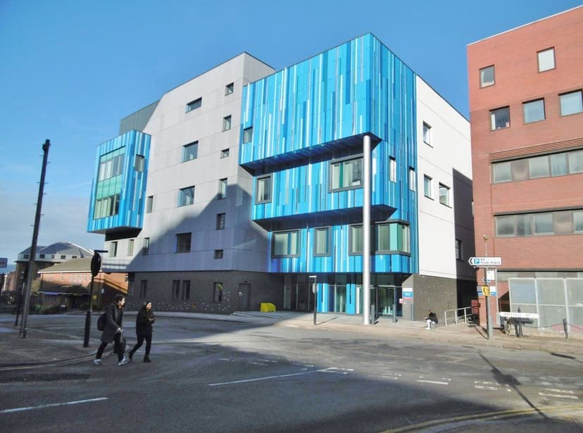 A modern hospital building on a city street.