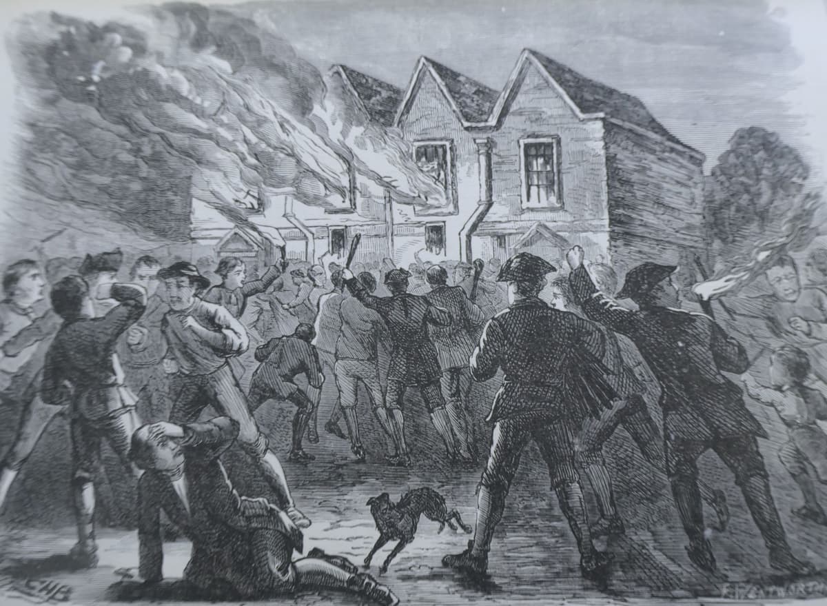 Engraving of a crowd attacking and setting fire to a chapel at night.