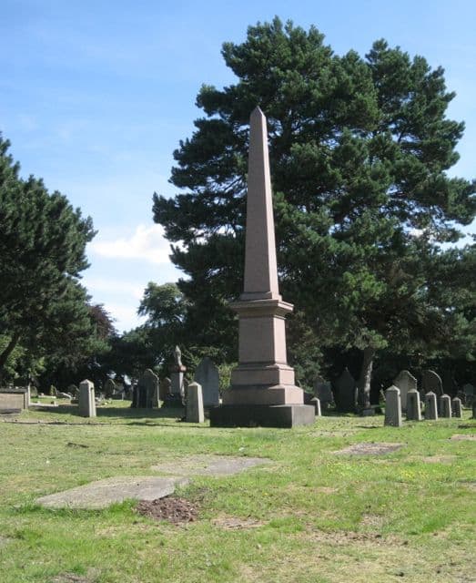 Rows of old gravestones in a cemetery.