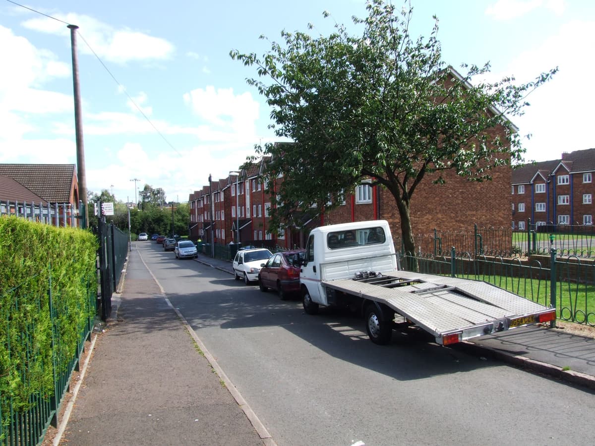 A quiet residential street of modern houses with a street sign reading Vauxhall Grove.