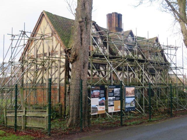 The timber-framed Golden Lion among trees in Cannon Hill Park in winter.