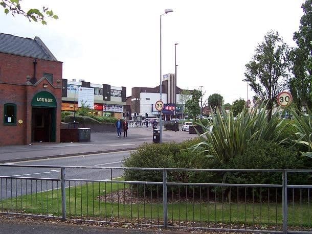 The Kingstanding pub's red-brick gable, the 1960s precinct shops and the white former Odeon, seen across the landscaped Circle in 2005