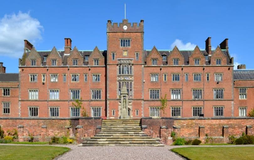 2013: The red-brick front of St Mary’s College, Oscott, with its central clock tower above steps and a lawn