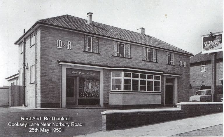 A new two-storey Mitchells & Butlers pub with M&B lettering, a Good Cheer Cellars off-licence window and a hanging sign reading Rest and Be Thankful