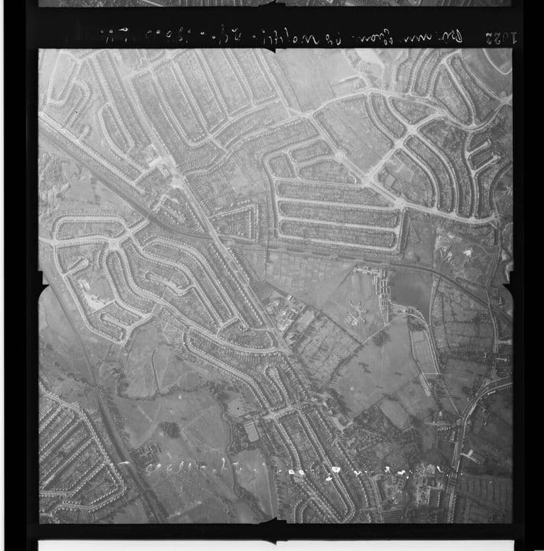 Wartime vertical air photo of Perry Barr and the Perry Beeches estate, with Perry Reservoir, the canal, the railway and a star-shaped gun emplacement on open ground