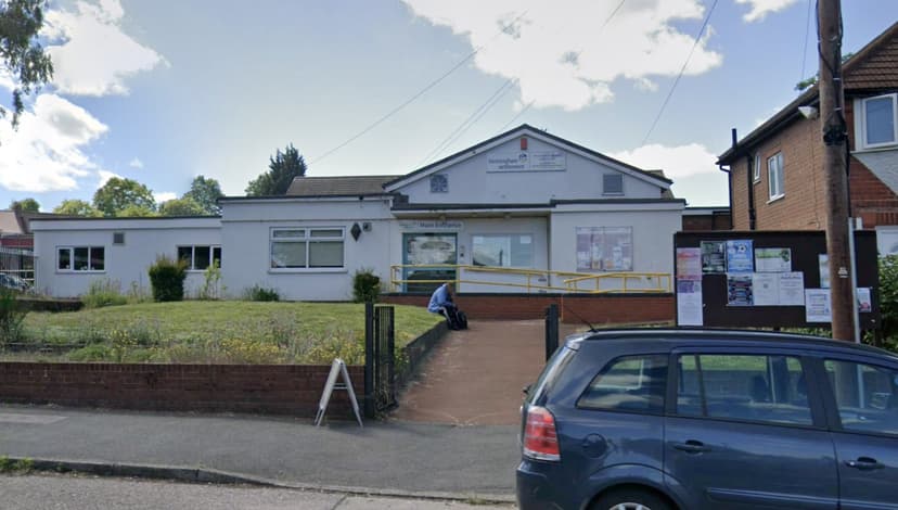 The Birmingham Settlement Sports & Community Centre on Kingstanding Road — a low white building with a Birmingham Settlement sign above the main entrance