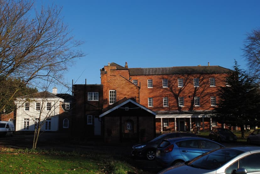 Maryvale House from the grounds, with a small brick shrine building in front