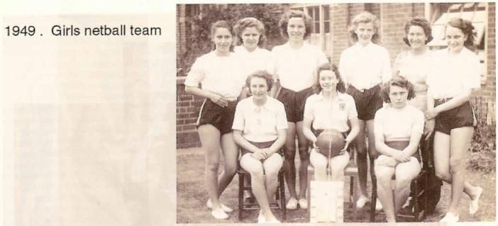 A scanned booklet page: nine girls in white blouses and dark shorts, three seated in front with a netball, outside a brick building. Printed beside it: “1949. Girls netball team”.