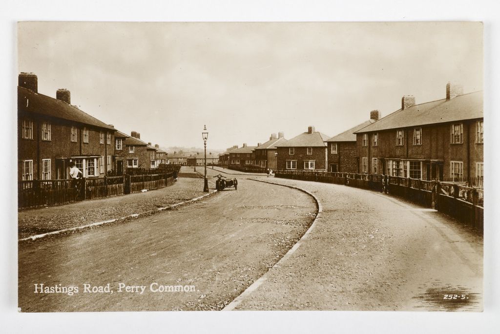 Sepia postcard of Hastings Road, Perry Common, curving between new houses, with a motorbike and sidecar on the road
