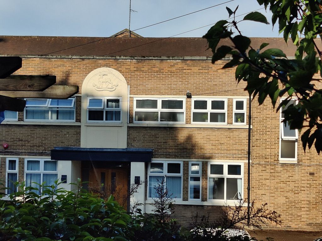 Close view of the Army Reserve Centre entrance: a white panel with a carved crest above a canopied doorway in a brick frontage.