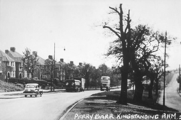 A tree-lined road with semi-detached houses, a car, a lorry and a double-decker bus, captioned Perry Barr Kingstanding.