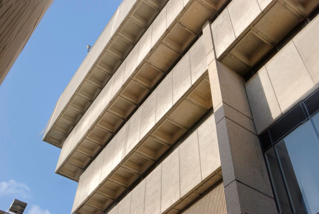 Close view of the concrete corner of the Central Library, each floor stepping out over the one below.