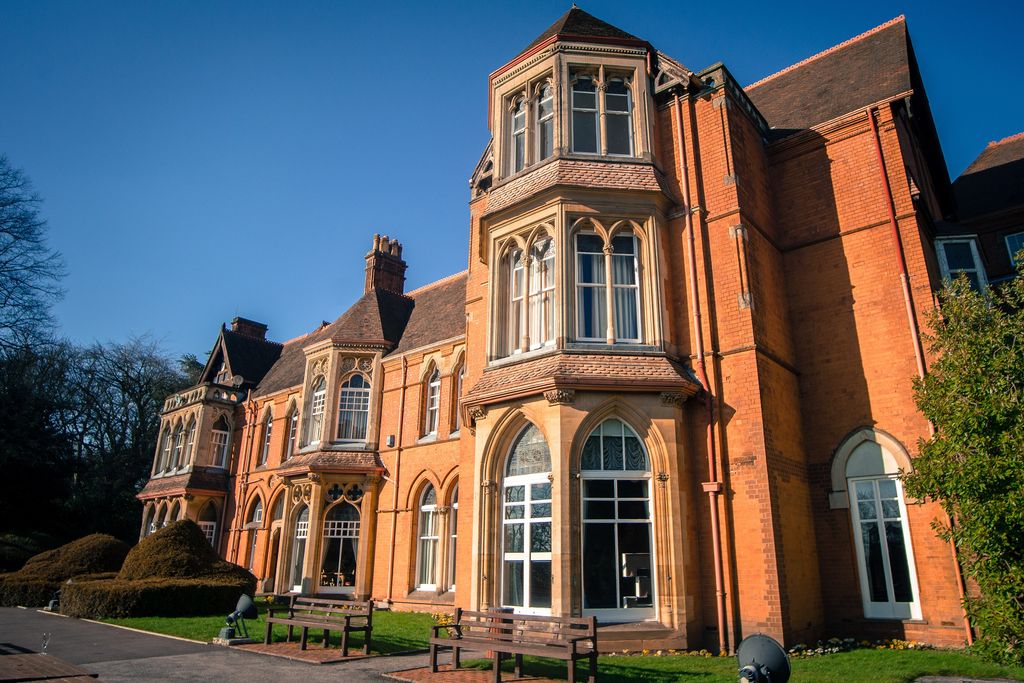 Highbury Hall’s red-brick front with carved stone and terracotta details.