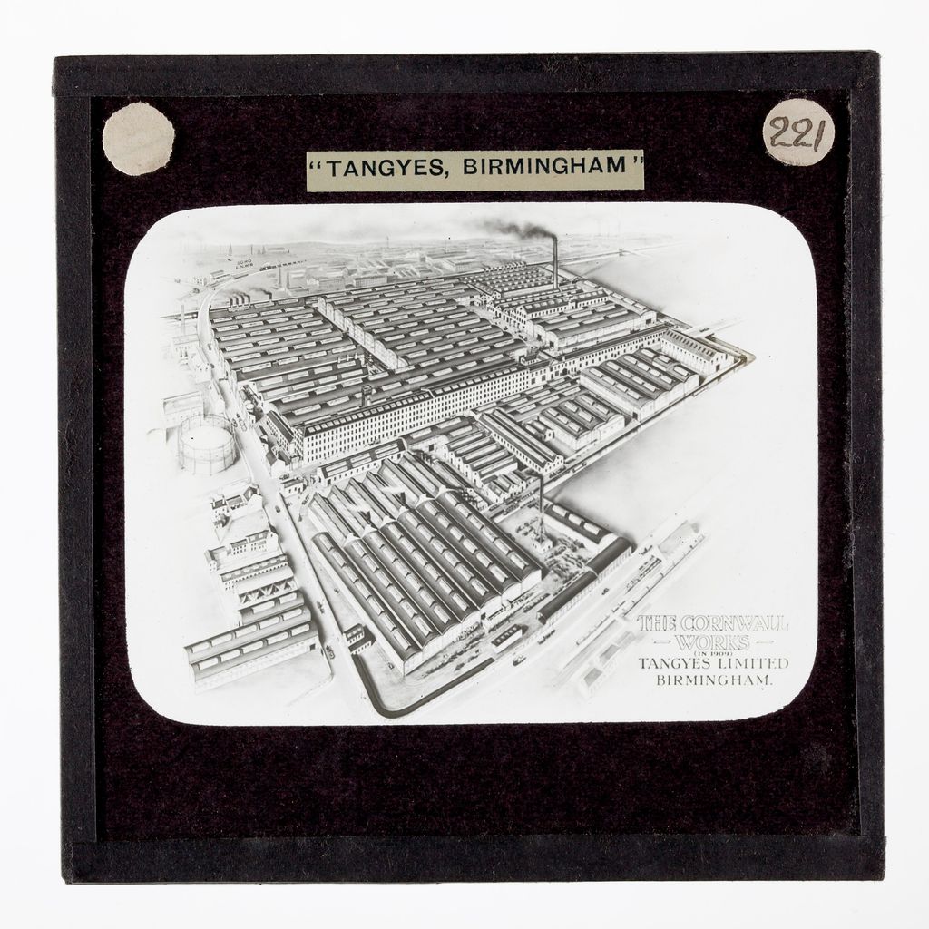 Bird’s-eye illustration of a large factory with many sheds and chimneys beside a canal and railway.