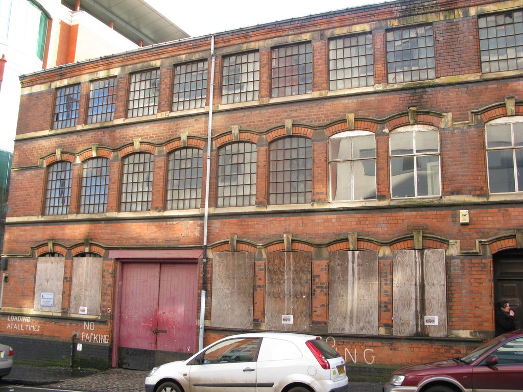 The brick front of a Victorian factory before restoration.