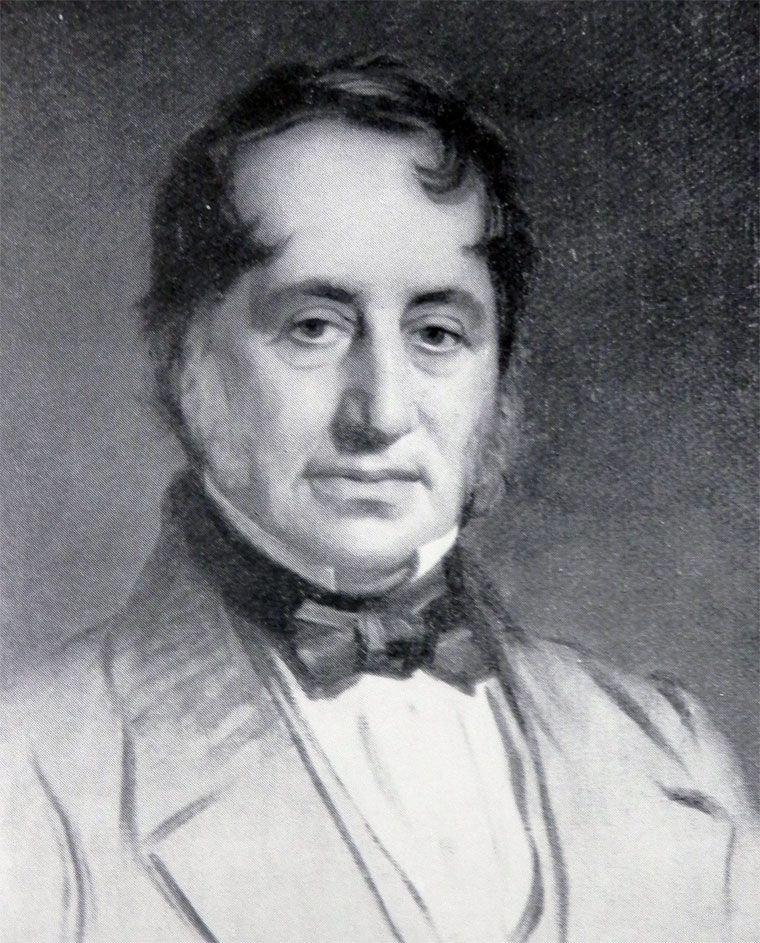 Black-and-white reproduction of a painted portrait of a middle-aged man with dark side-whiskers, a high collar and a dark bow-tied stock.