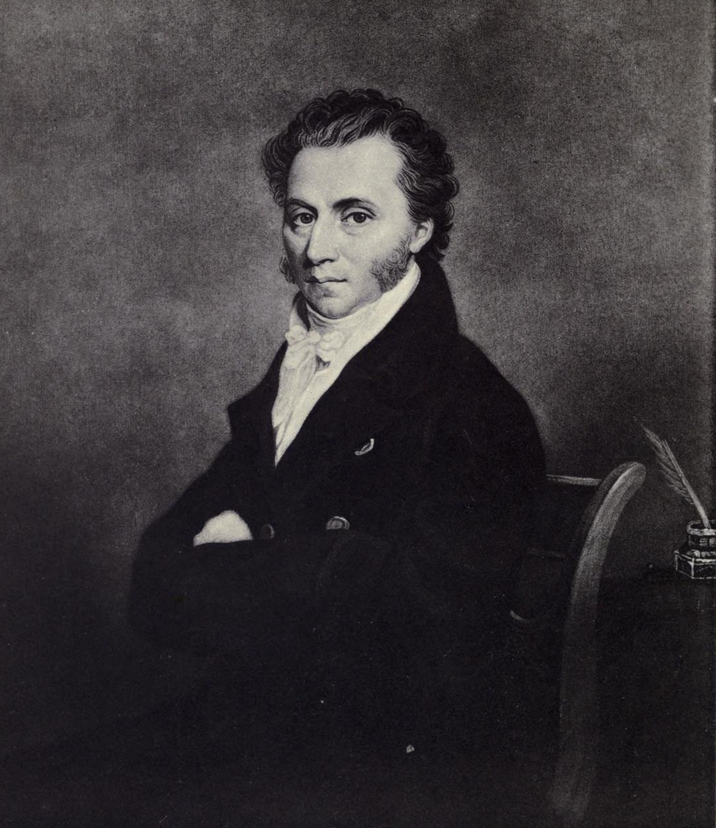 Engraved portrait of a seated man with dark curly hair and side whiskers, in a dark coat and white neckcloth, his arms folded.