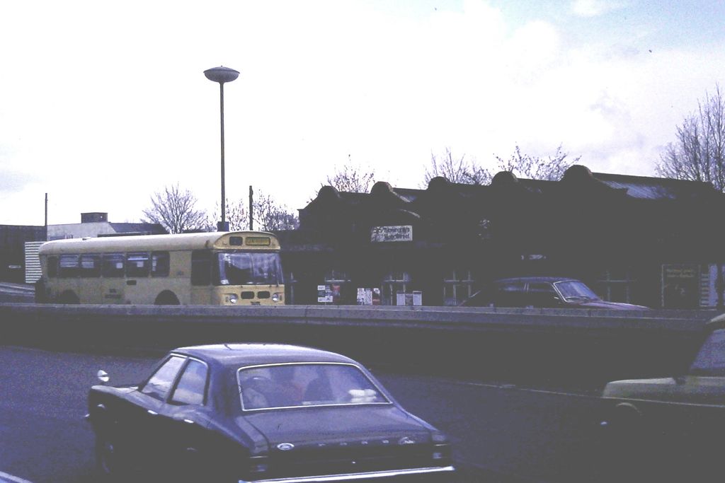 Cars speeding down a wide urban road.