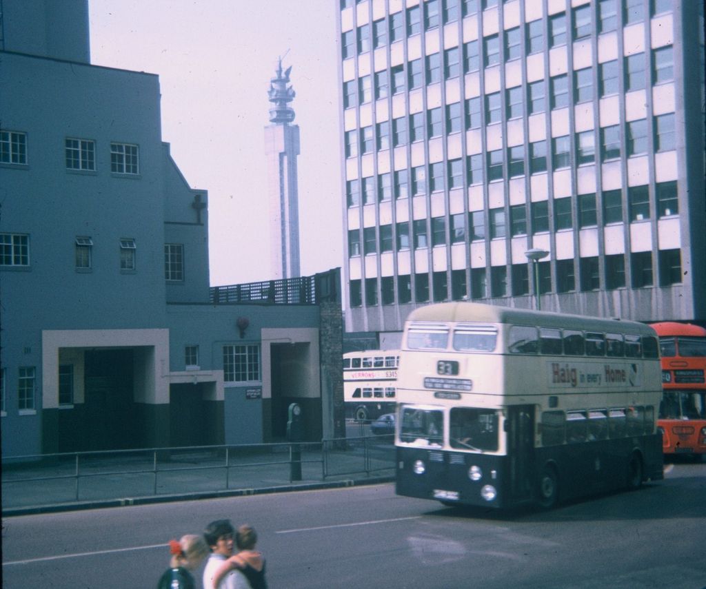 Double-decker buses at a city-centre road junction.