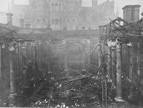 Engraving of a burnt-out library interior open to the sky, with a Gothic building visible beyond.