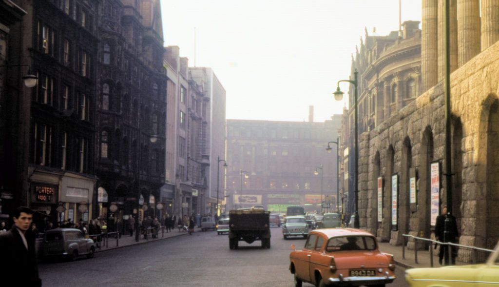 Colour street photograph with the columns of the Town Hall on the right and Victorian buildings lining the road ahead.