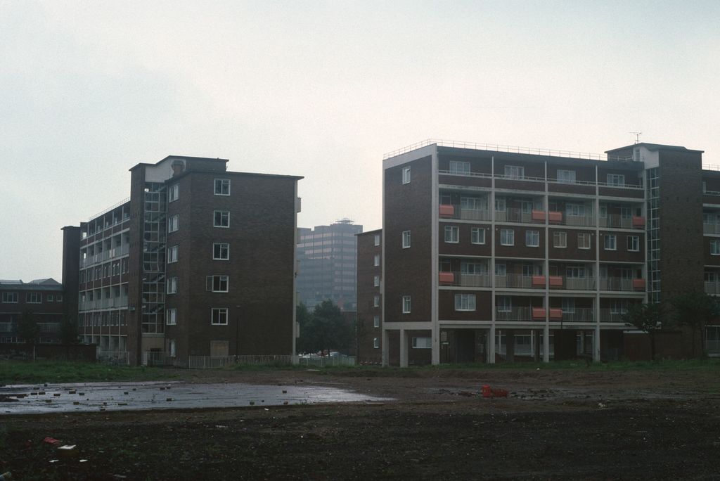 Six-storey council flats set in open grassed space.